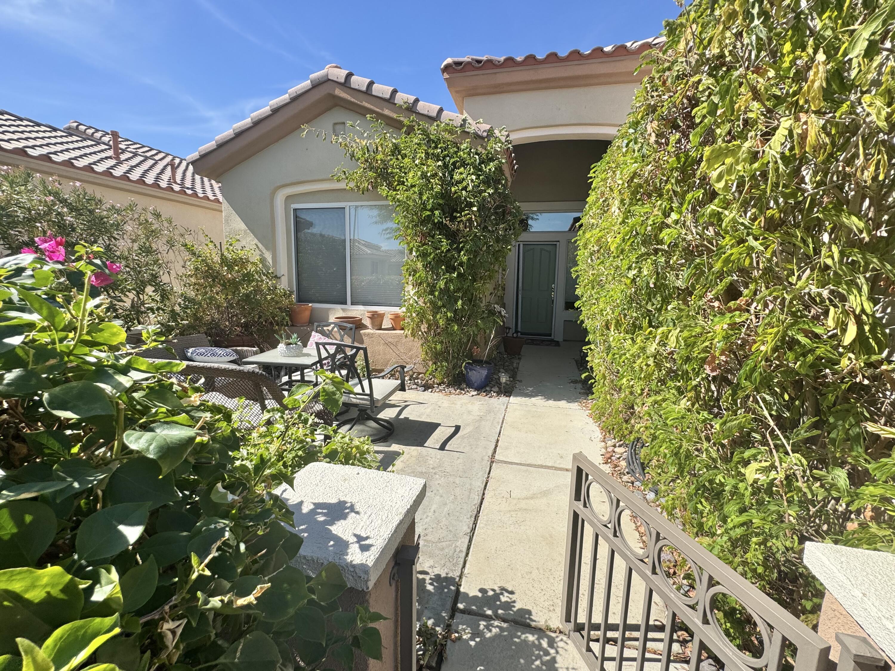 78322 Vinewood Drive Palm Desert, CA 92211 - Photo 3 of 30 a view of a house with potted plants