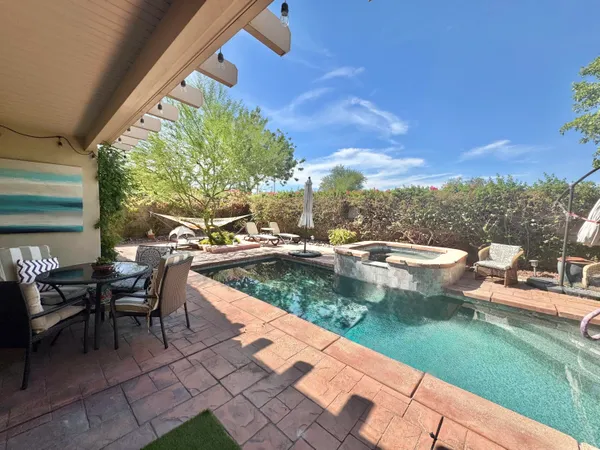 a view of a swimming pool with a lounge chairs