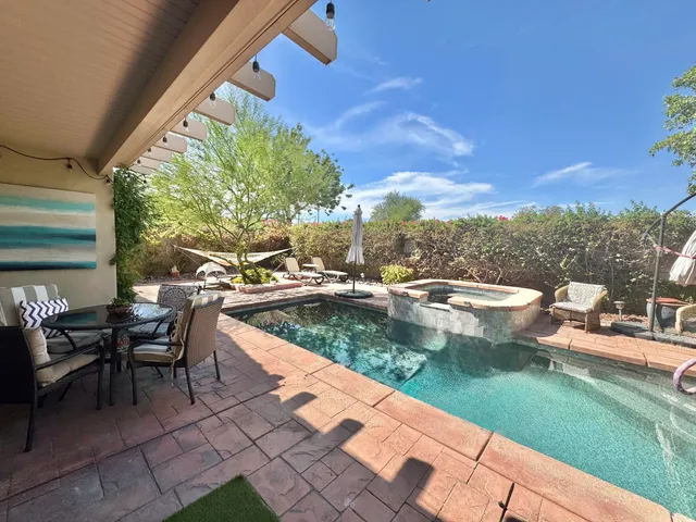 a view of a swimming pool with a lounge chairs