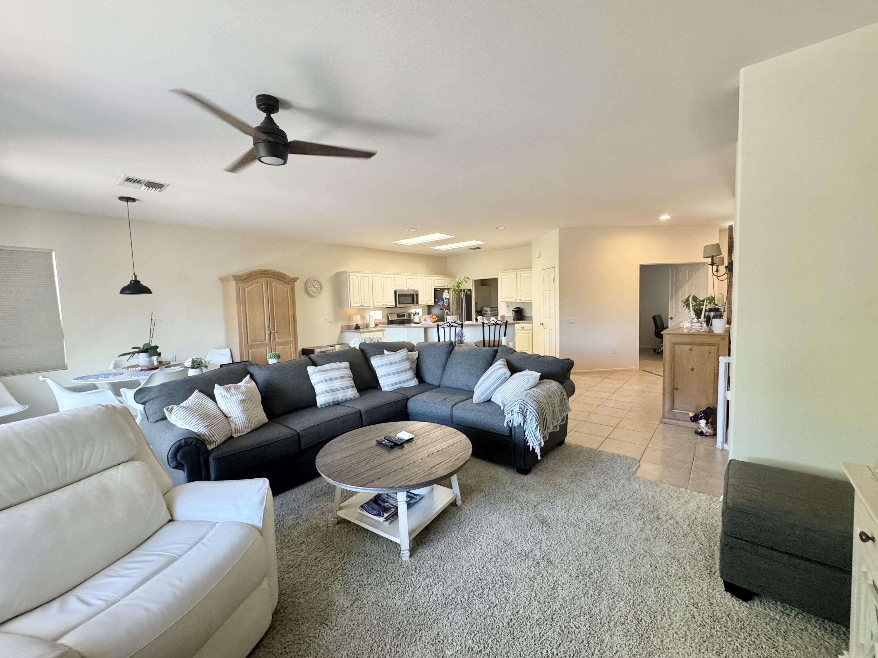 78322 Vinewood Drive Palm Desert, CA 92211 - Photo 10 of 30 a living room with furniture and a ceiling fan