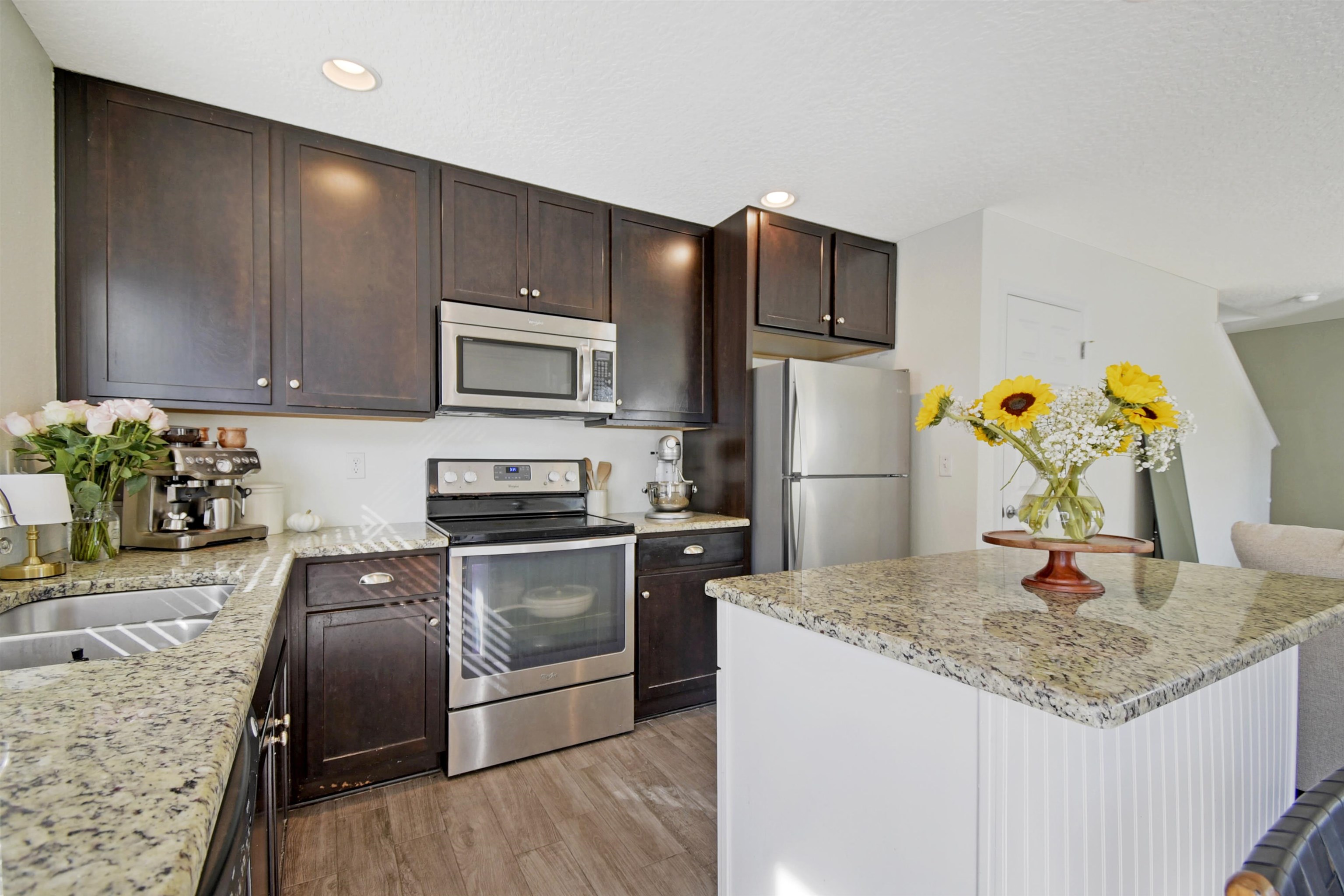 323 Islander Circle St. Augustine, FL 32080 - Photo 13 of 36 a kitchen with stainless steel appliances granite countertop a refrigerator a stove top oven a sink and dishwasher