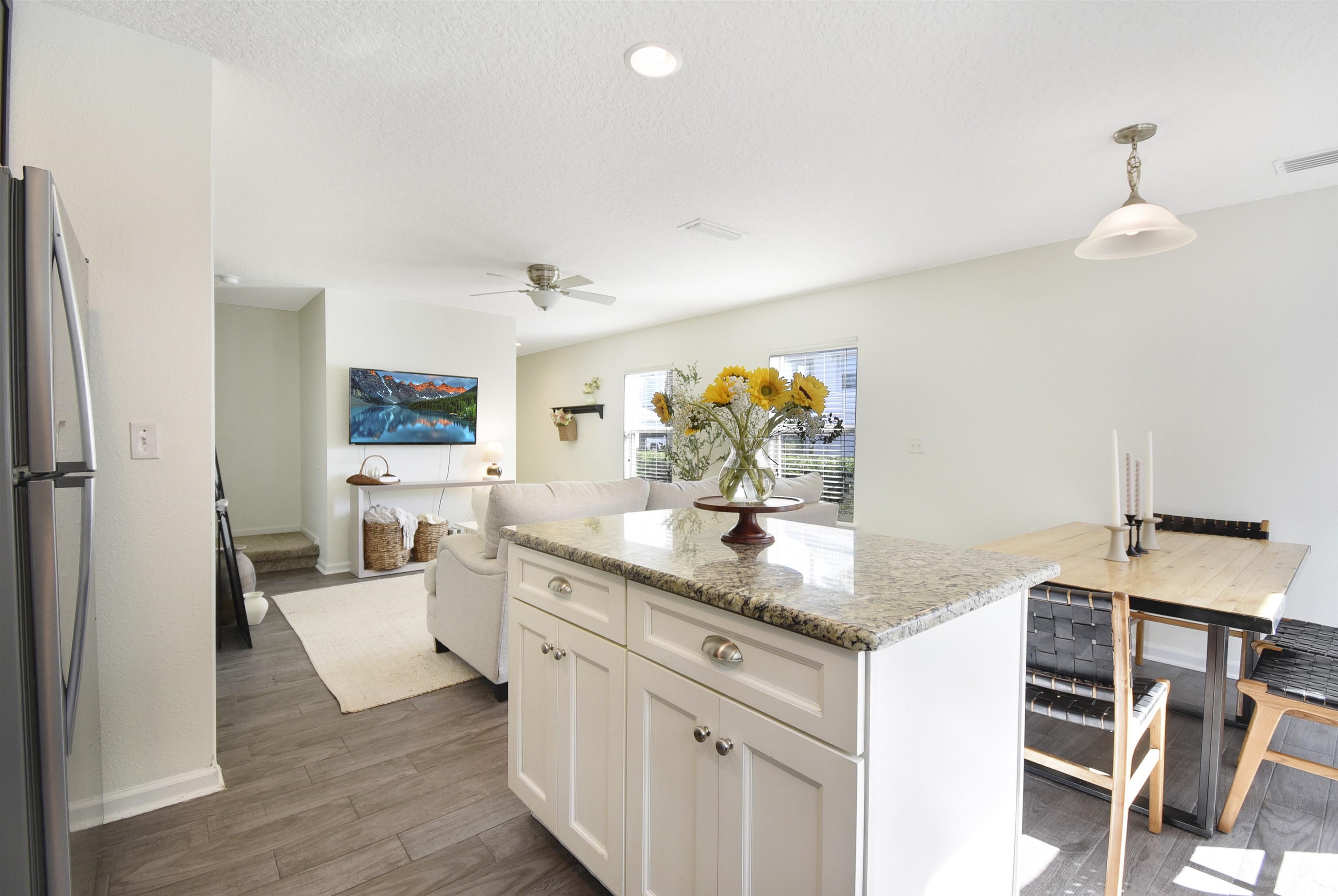 323 Islander Circle St. Augustine, FL 32080 - Photo 15 of 36 a kitchen with stainless steel appliances granite countertop a sink dishwasher and a refrigerator with wooden floor