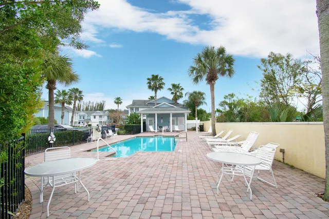 a view of a street with a yard and a large tree