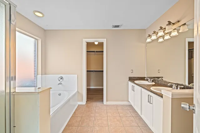 a kitchen with stainless steel appliances granite countertop a sink and a refrigerator