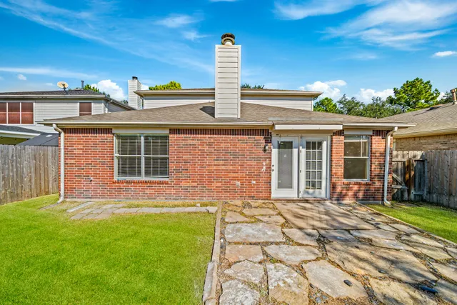 a front view of a house with a garden and plants
