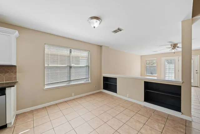a view of room with window and kitchen view