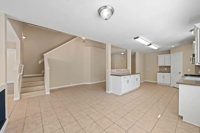 a view of kitchen with cabinets and window