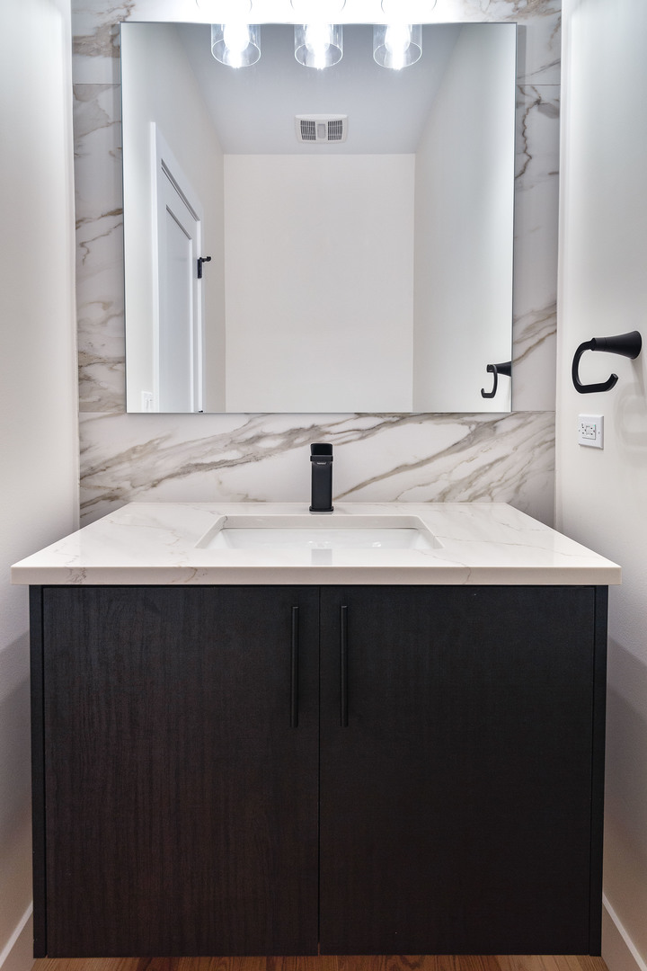 3015 North Normandy Avenue Chicago, IL 60634 - Photo 11 of 28 a bathroom with a sink and a mirror