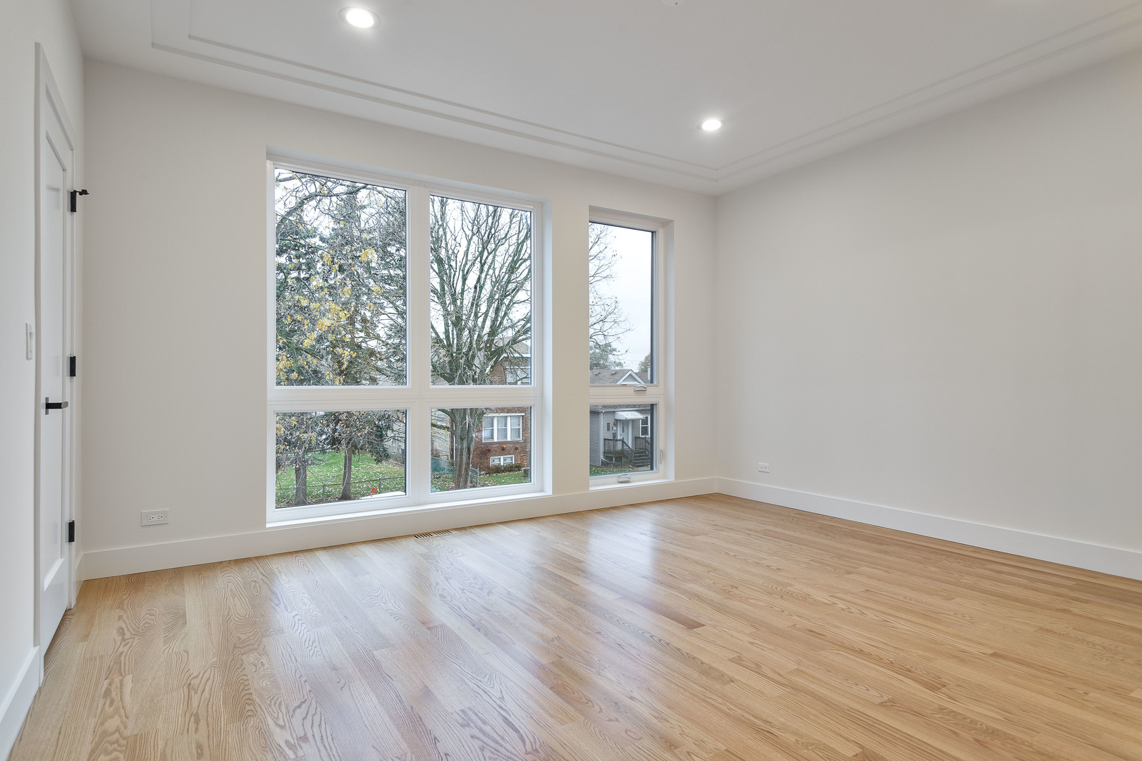 3015 North Normandy Avenue Chicago, IL 60634 - Photo 12 of 28 wooden floor in an empty room with a window