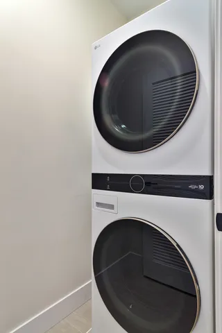 a washer and dryer sitting next to a wooden floor