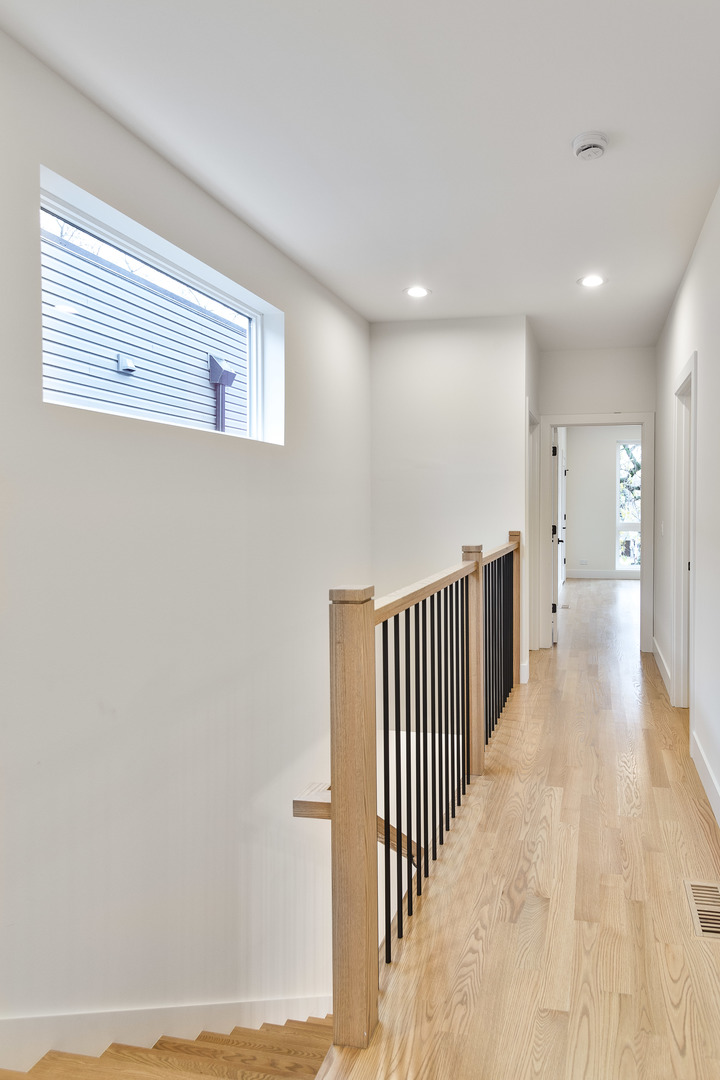 3015 North Normandy Avenue Chicago, IL 60634 - Photo 21 of 28 a view of a hallway with wooden floor