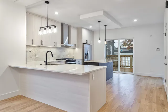 a kitchen with counter top space sink and refrigerator