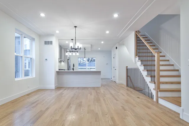 a view of kitchen and hall with wooden floor