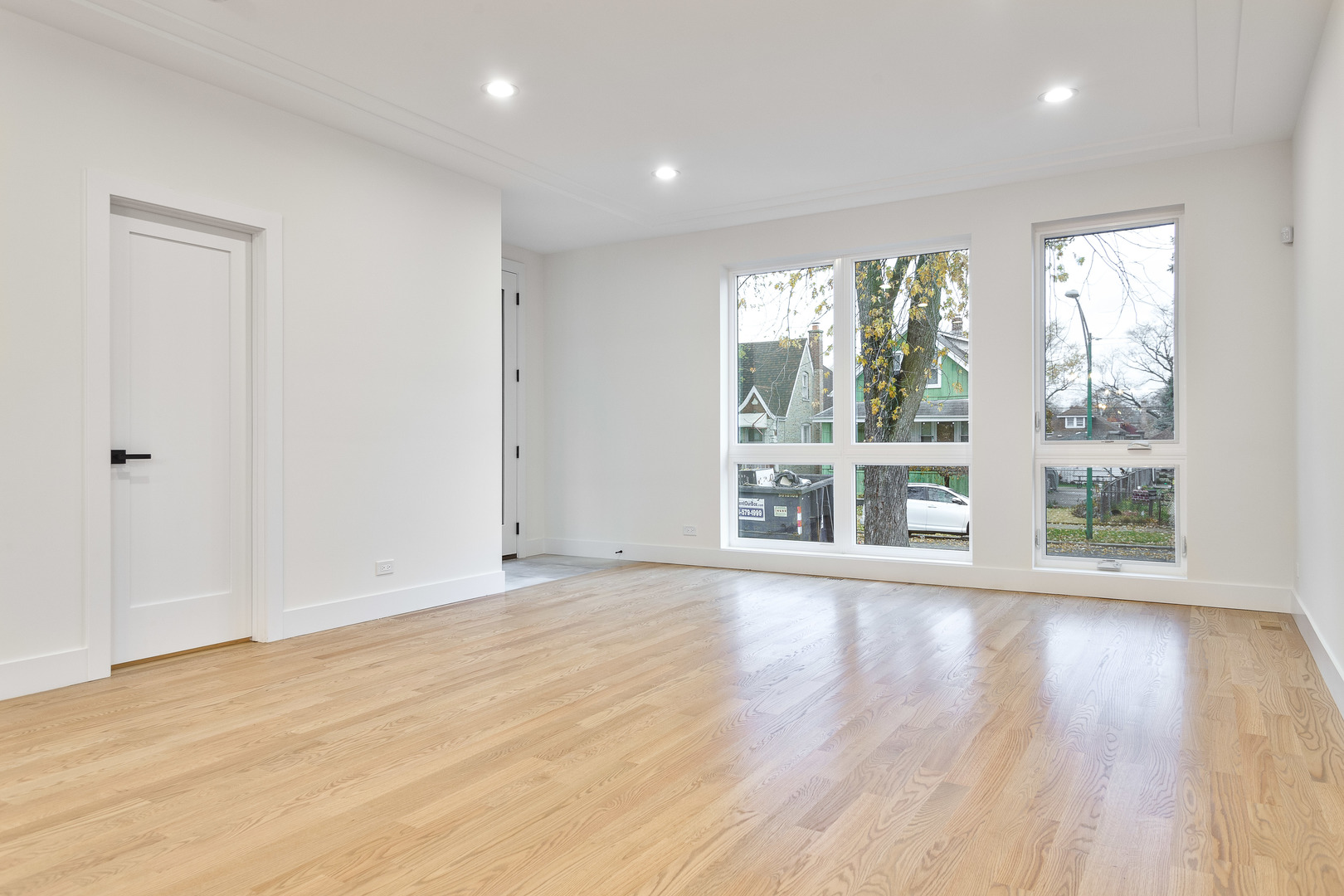 3015 North Normandy Avenue Chicago, IL 60634 - Photo 10 of 28 a view of an empty room with wooden floor and a window