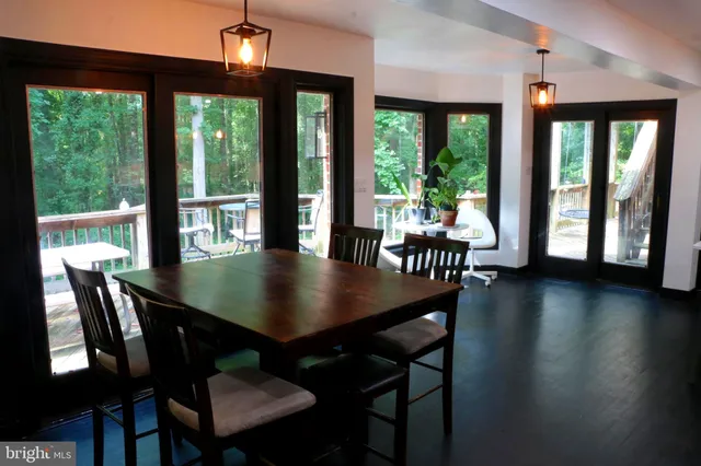 a dining room with furniture a chandelier and a window