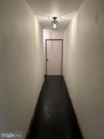 a bedroom with a bed lamp and a dresser