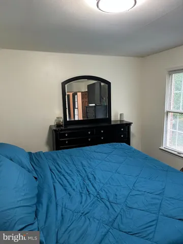 a bedroom with a bed and wall painting