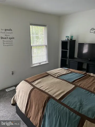 a bedroom with a bed and a view of bedroom