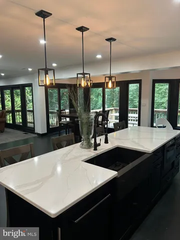 a living room with furniture pool table and a large window