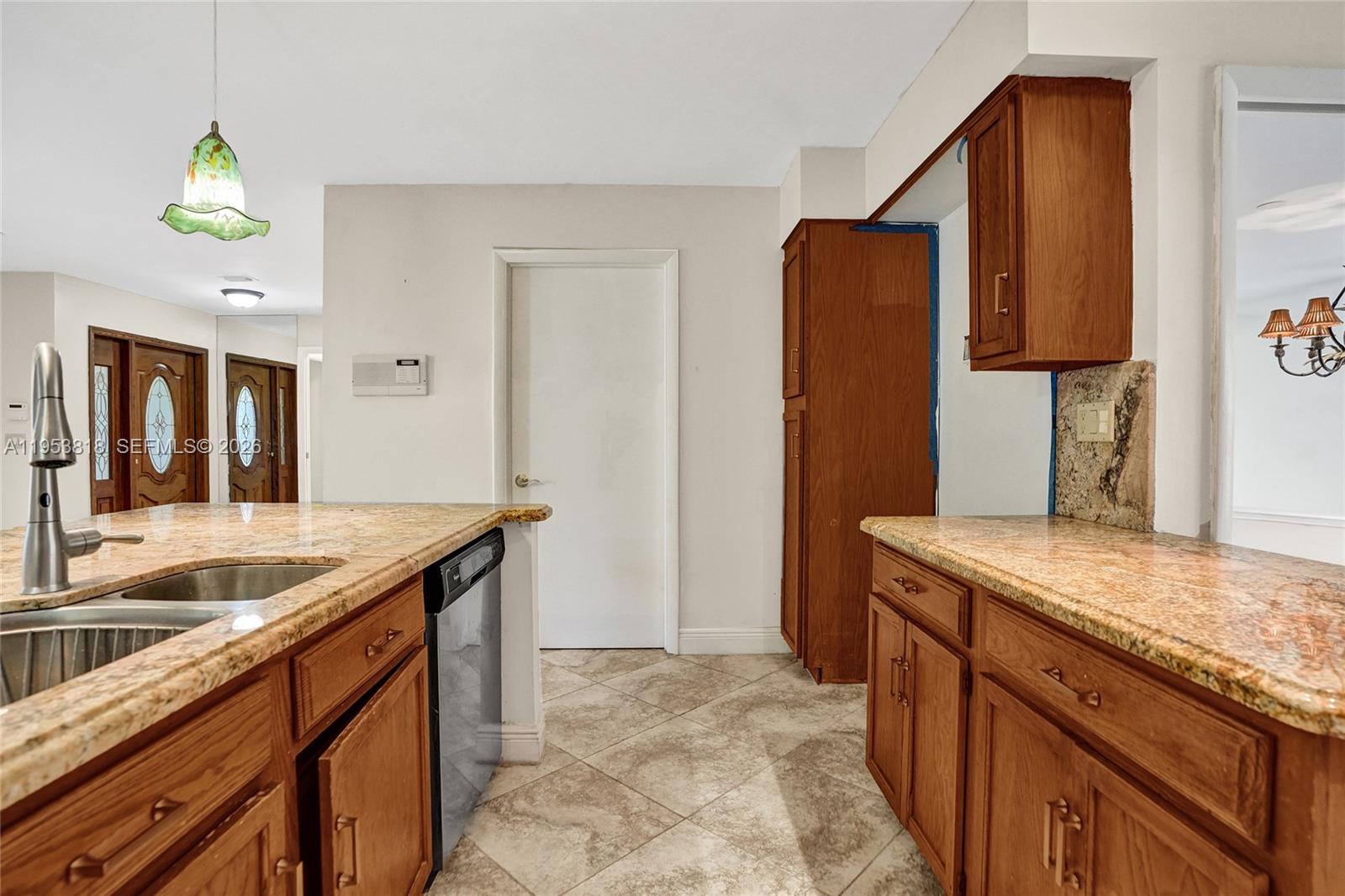 17115 Bay Street Jupiter, FL 33477 - Photo 13 of 73 a kitchen with stainless steel appliances granite countertop a sink and a refrigerator