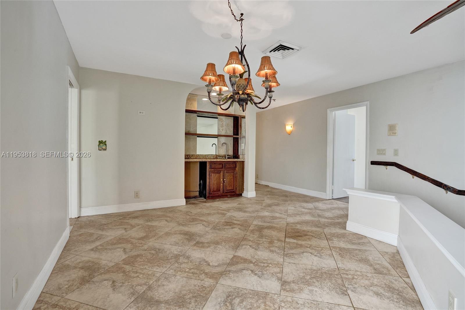 17115 Bay Street Jupiter, FL 33477 - Photo 23 of 73 a view of a hallway with a chandelier