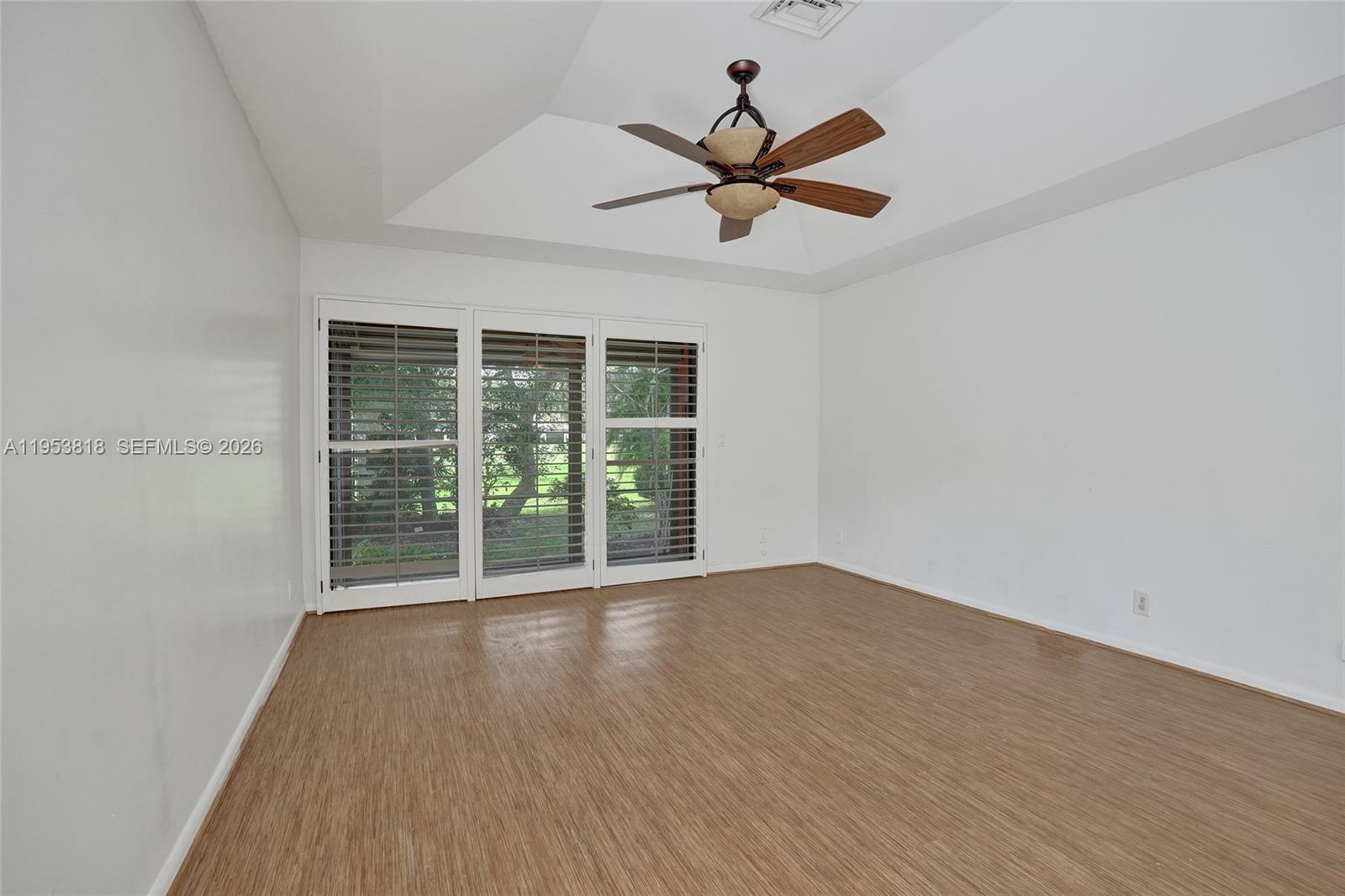17115 Bay Street Jupiter, FL 33477 - Photo 27 of 73 a view of an empty room with wooden floor and a window