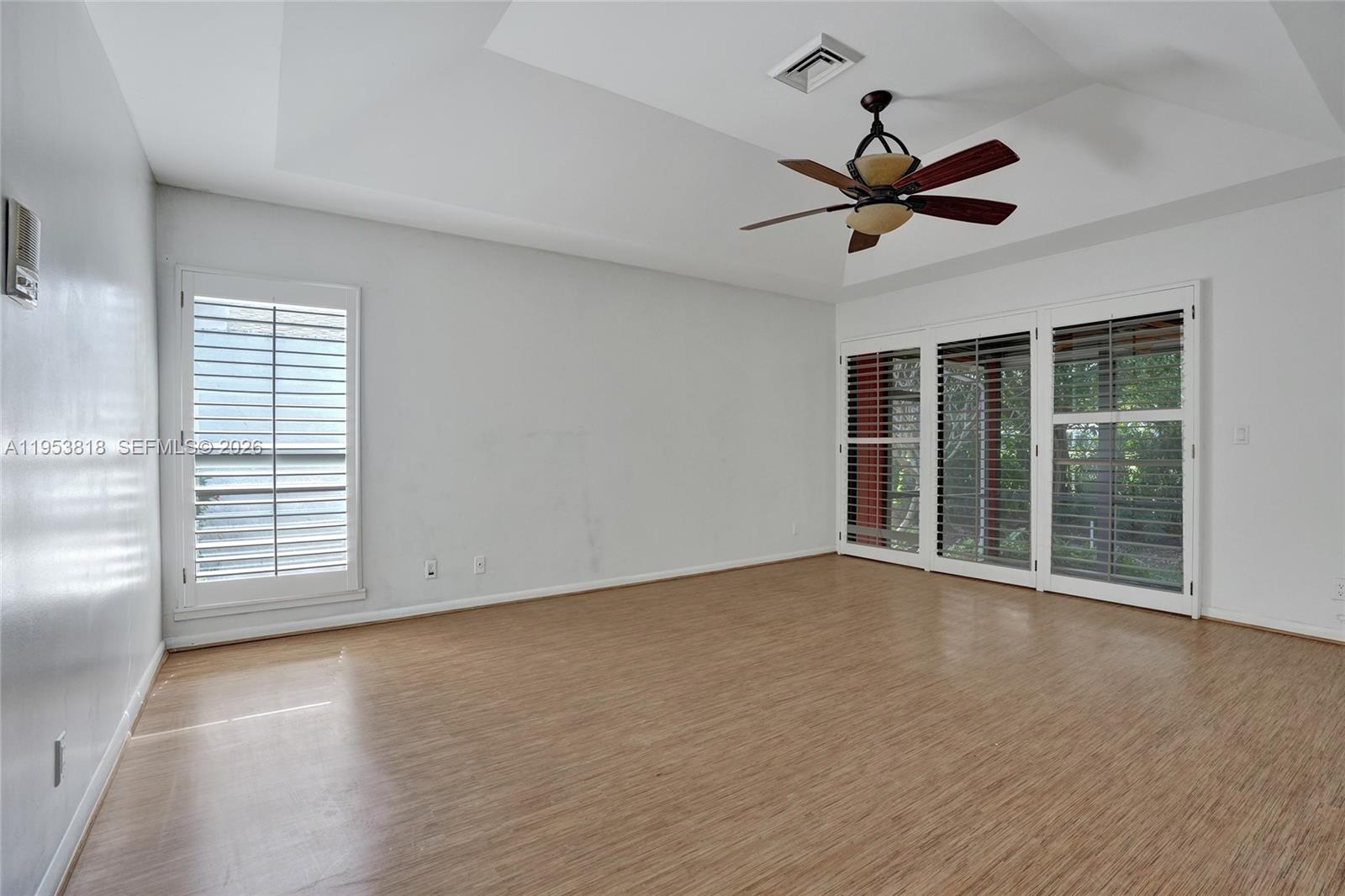 17115 Bay Street Jupiter, FL 33477 - Photo 29 of 73 a view of an empty room with wooden floor and a window