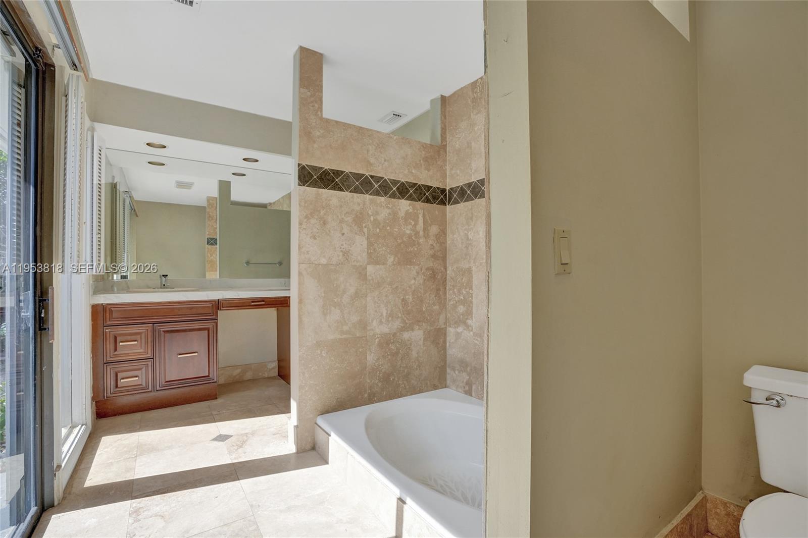 17115 Bay Street Jupiter, FL 33477 - Photo 32 of 73 a bathroom with a shower and a sink