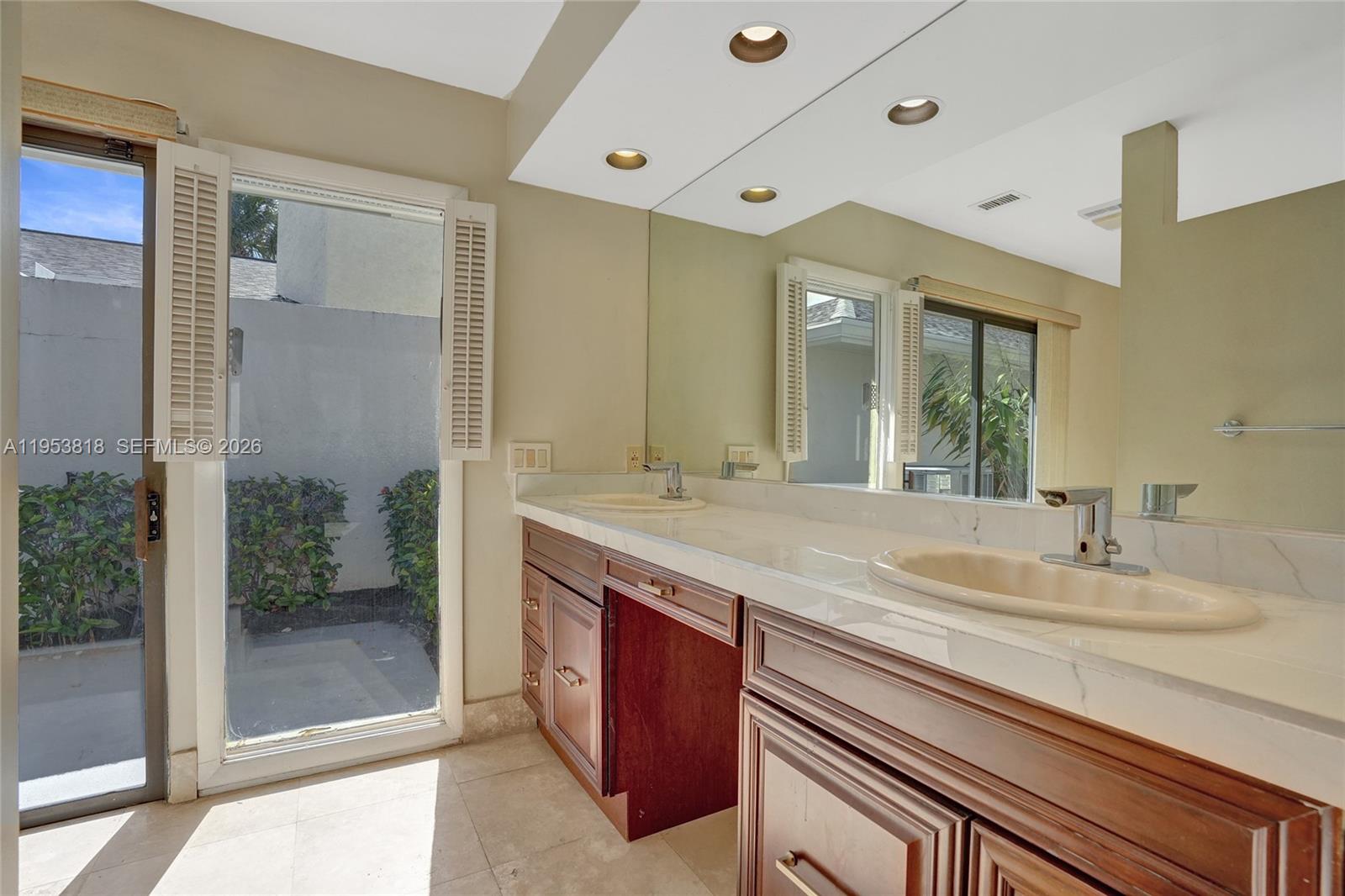 17115 Bay Street Jupiter, FL 33477 - Photo 33 of 73 a bathroom with a granite countertop sink mirror and double