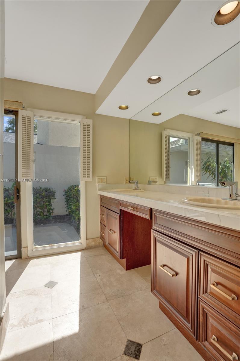 17115 Bay Street Jupiter, FL 33477 - Photo 34 of 73 a spacious bathroom with a granite countertop sink mirror and shower