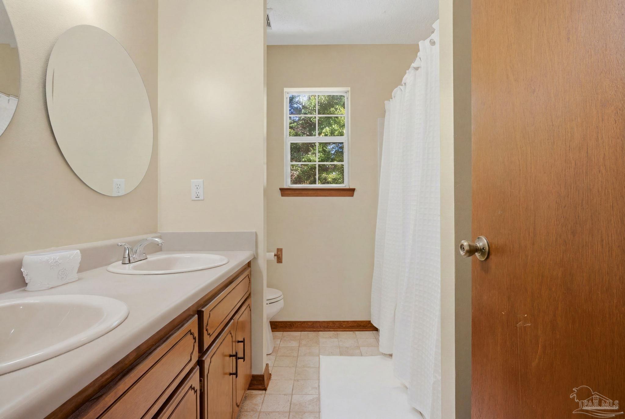 6870 Martin Road Milton, FL 32570 - Photo 34 of 48 a bathroom with a sink and a mirror