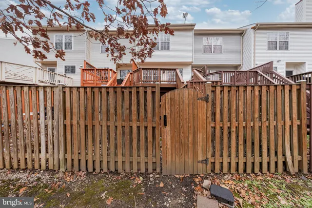 a view of a house with wooden fence