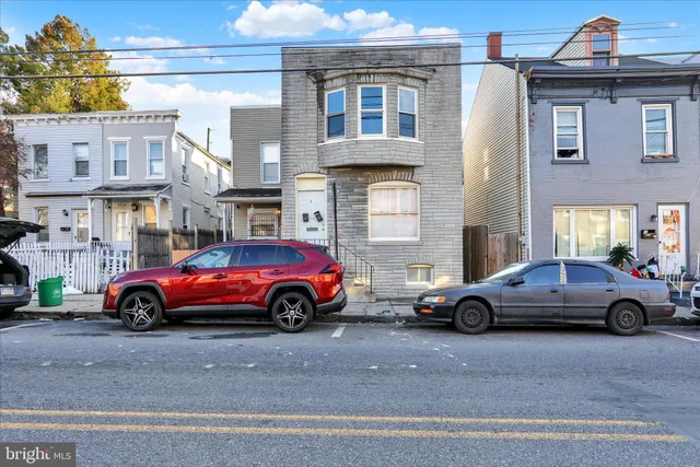 a front view of a house with parking space