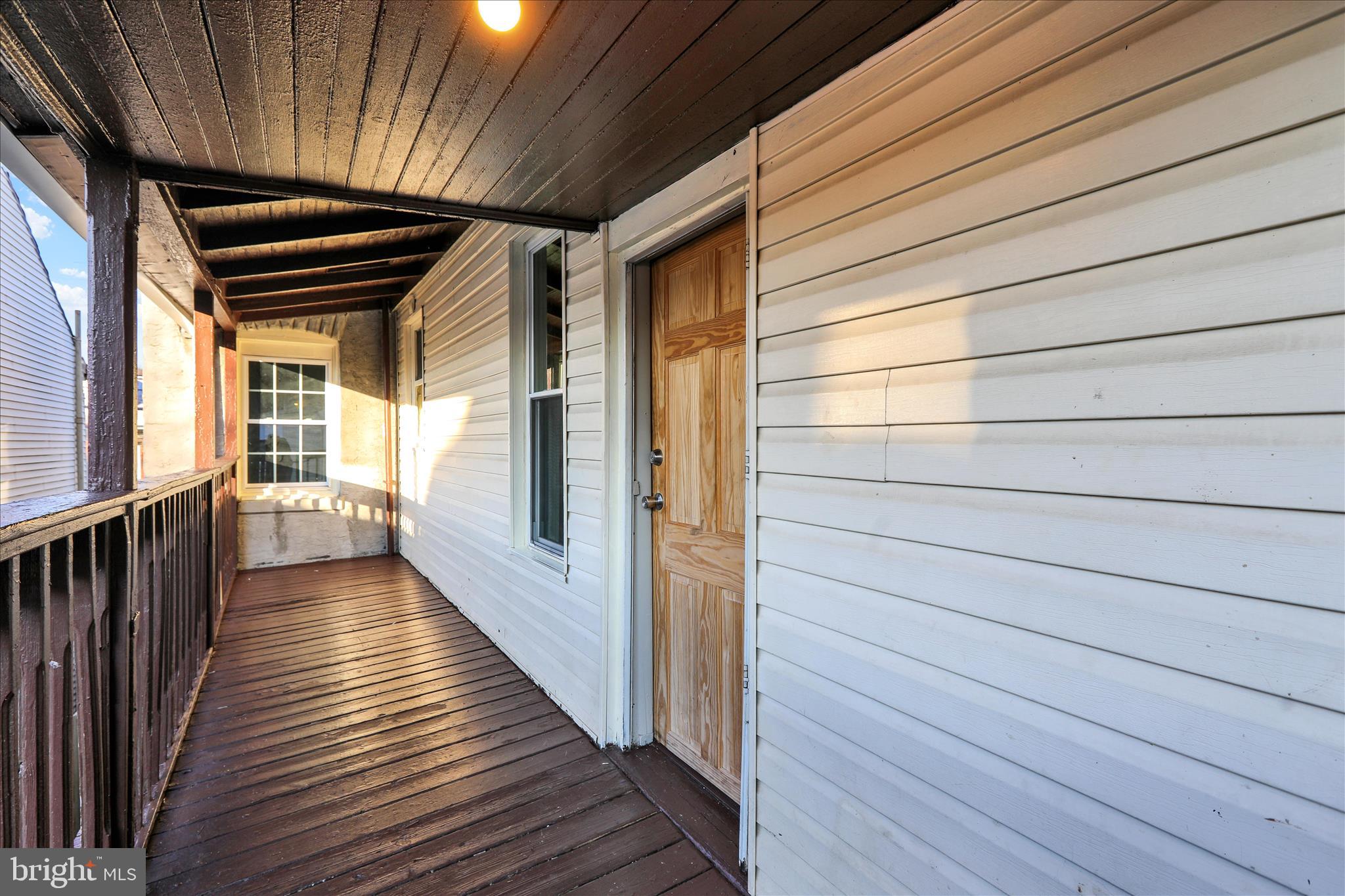 1410 Cotton Street Reading, PA 19602 - Photo 12 of 37 a view of a hallway with wooden floor and staircase