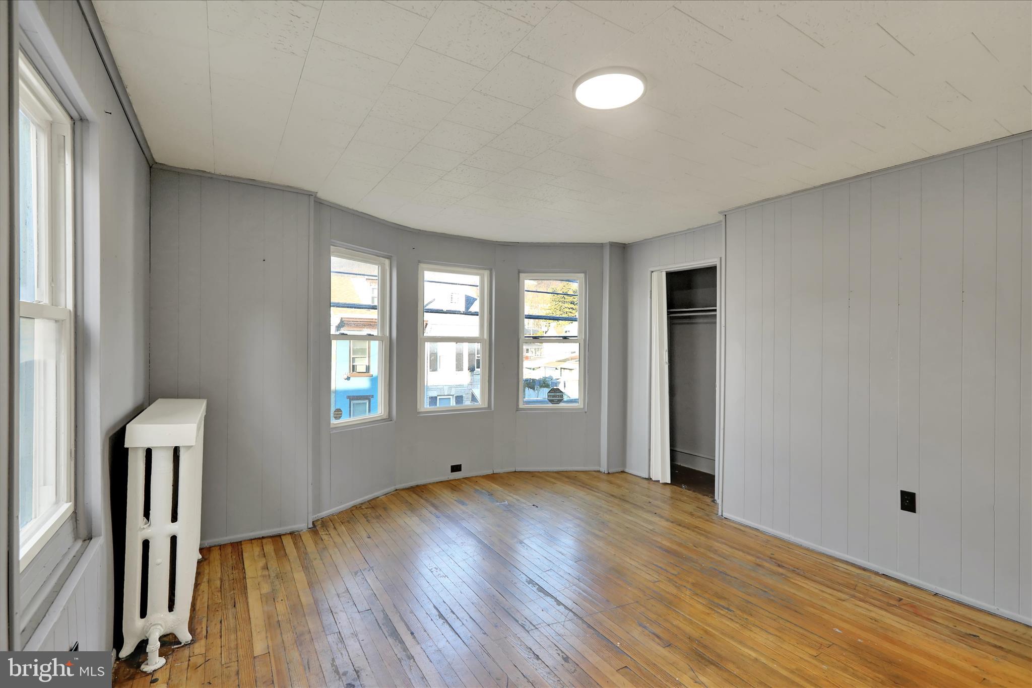 1410 Cotton Street Reading, PA 19602 - Photo 13 of 37 a view of empty room with wooden floor and fan