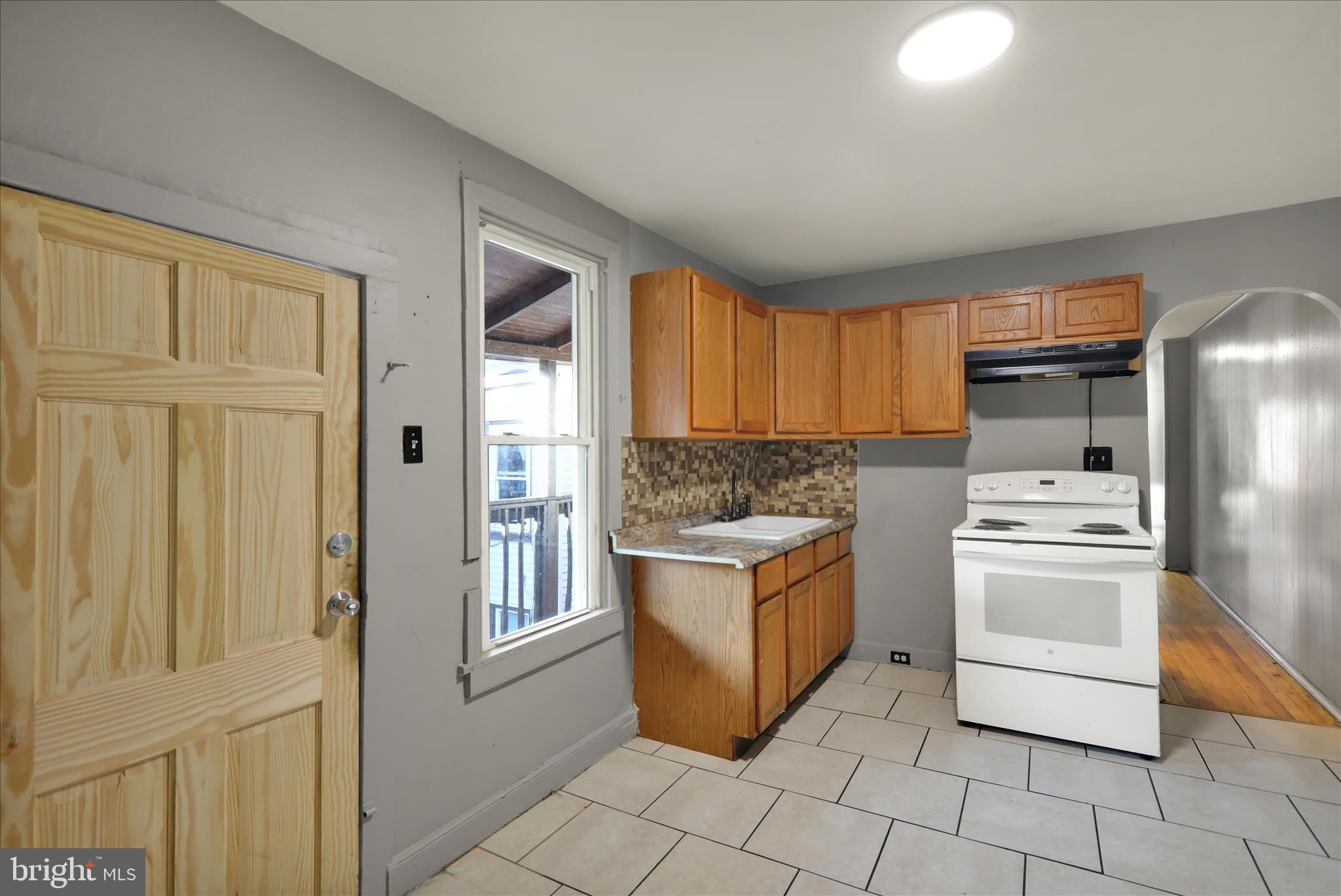 1410 Cotton Street Reading, PA 19602 - Photo 18 of 37 a kitchen with stainless steel appliances granite countertop a stove a sink and a refrigerator