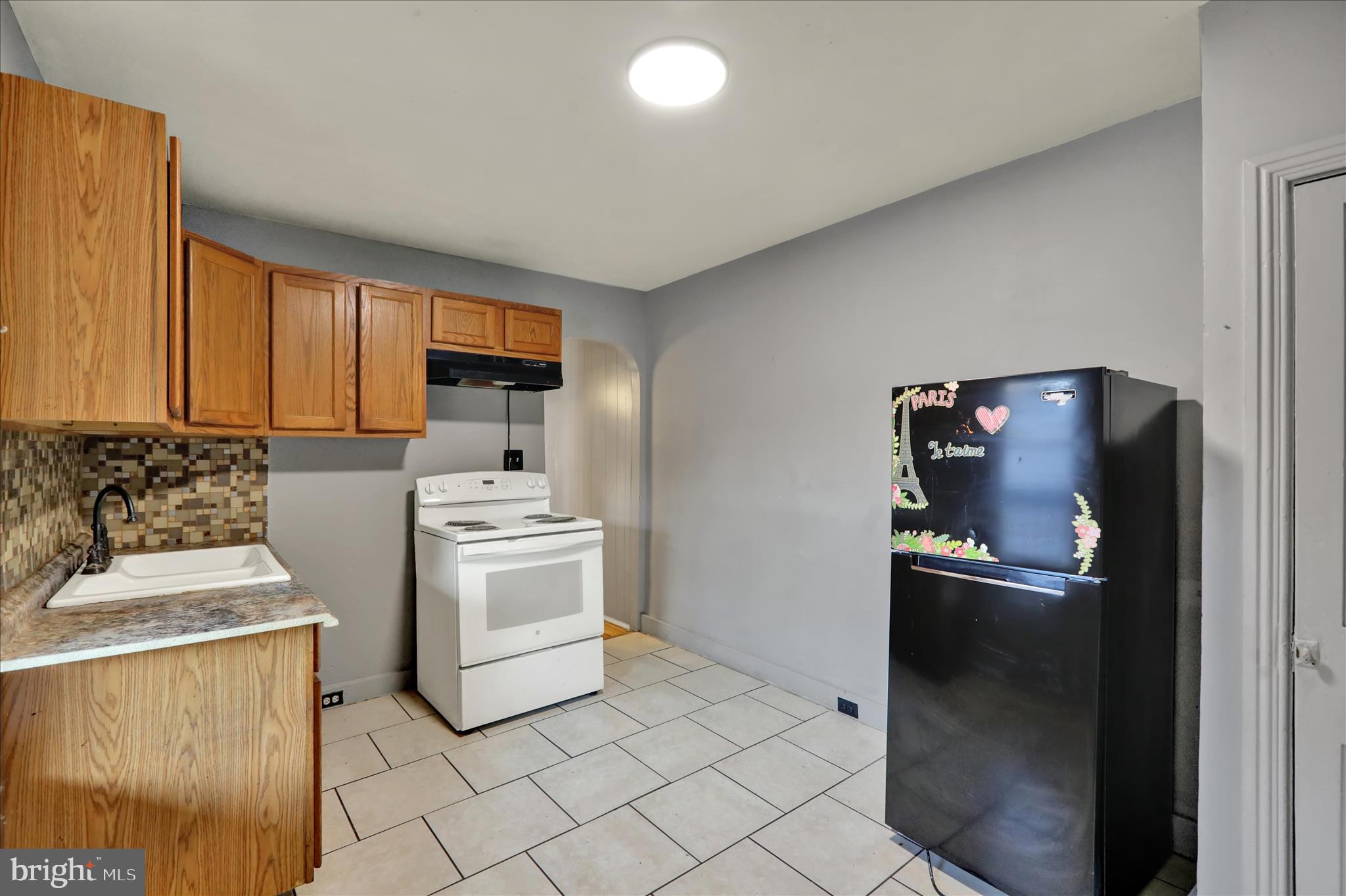 1410 Cotton Street Reading, PA 19602 - Photo 19 of 37 a kitchen with a stove top oven and cabinets