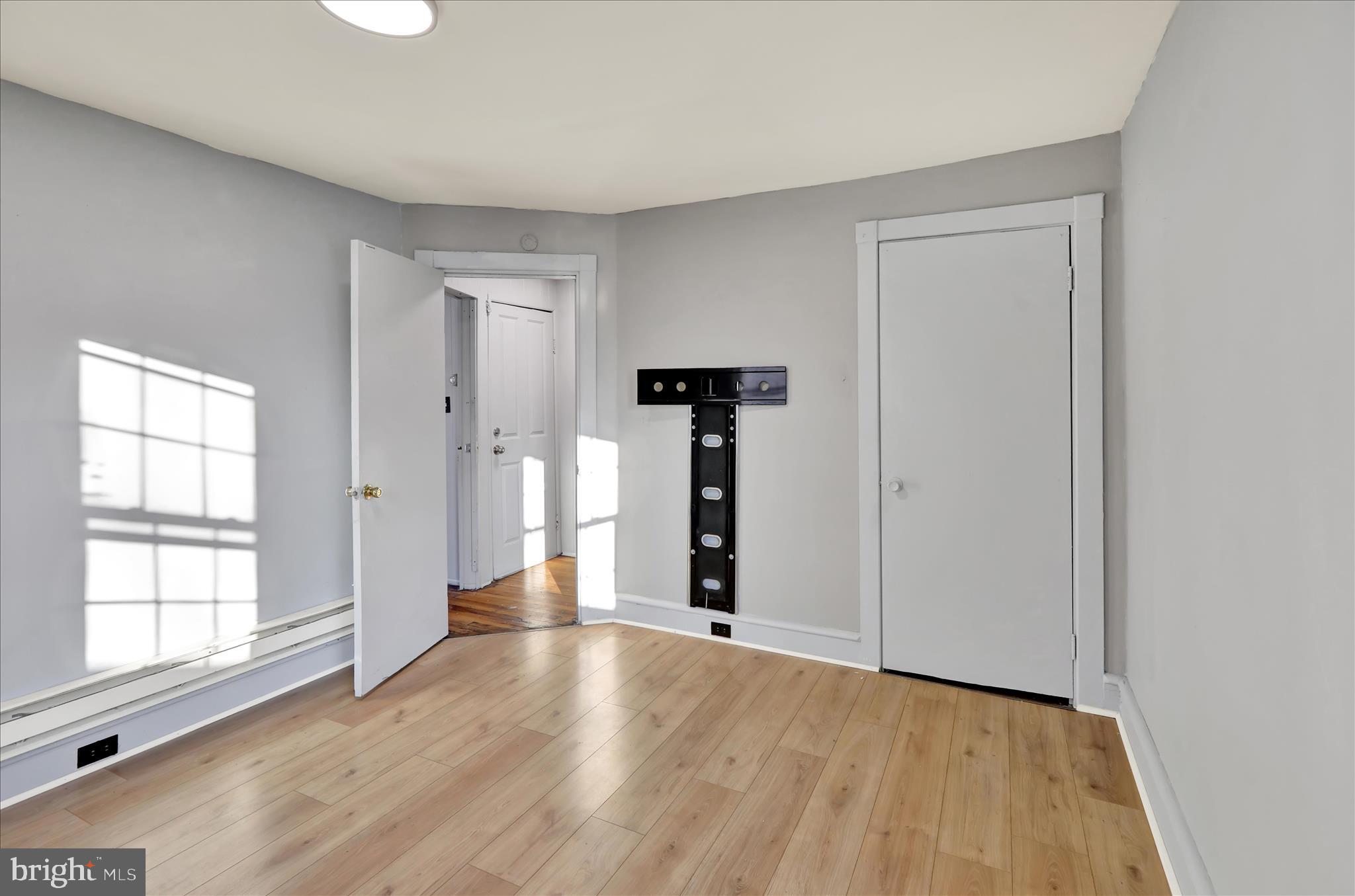 1410 Cotton Street Reading, PA 19602 - Photo 22 of 37 wooden floor in an empty room with a window