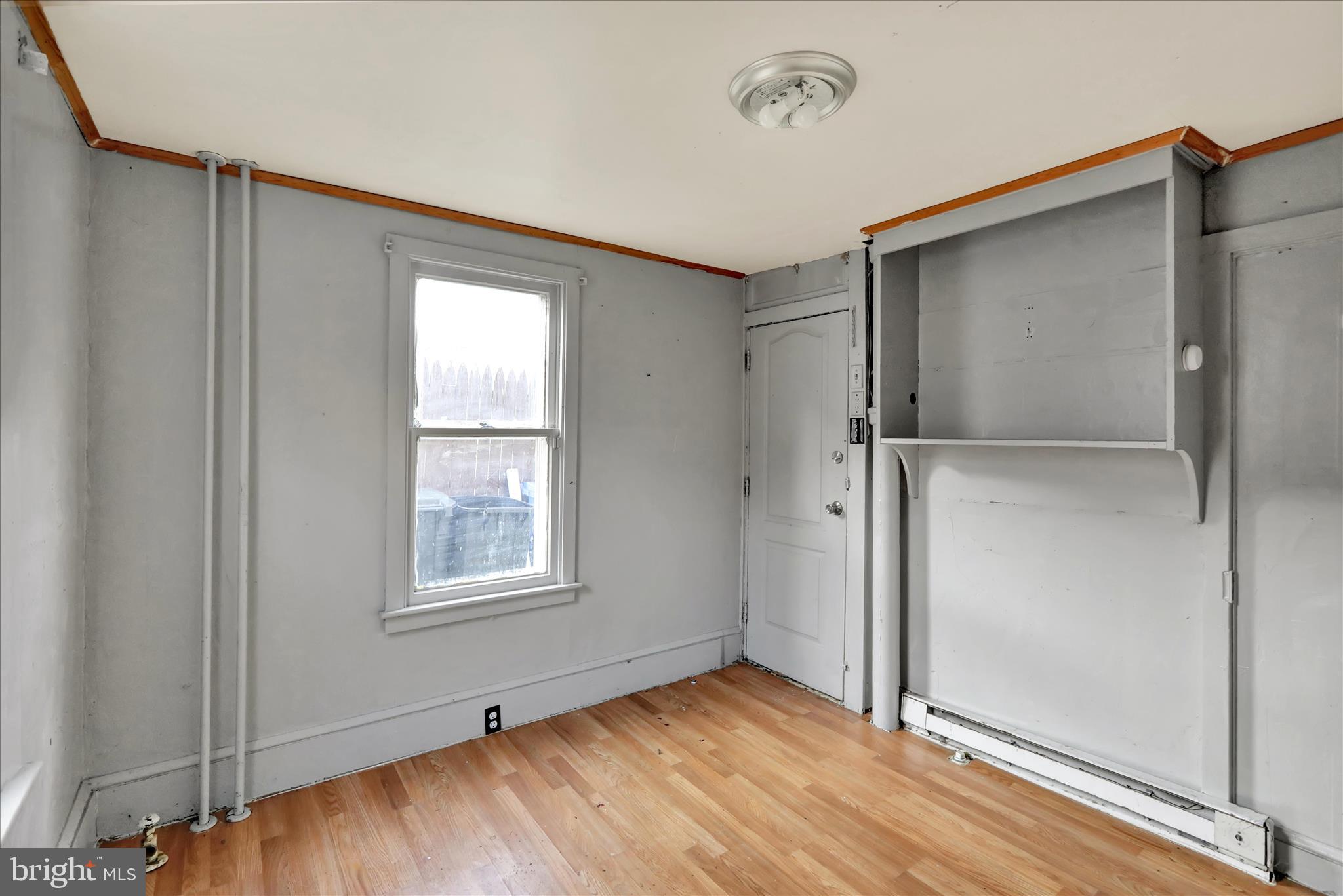 1410 Cotton Street Reading, PA 19602 - Photo 25 of 37 a view of an empty room with wooden floor and a window