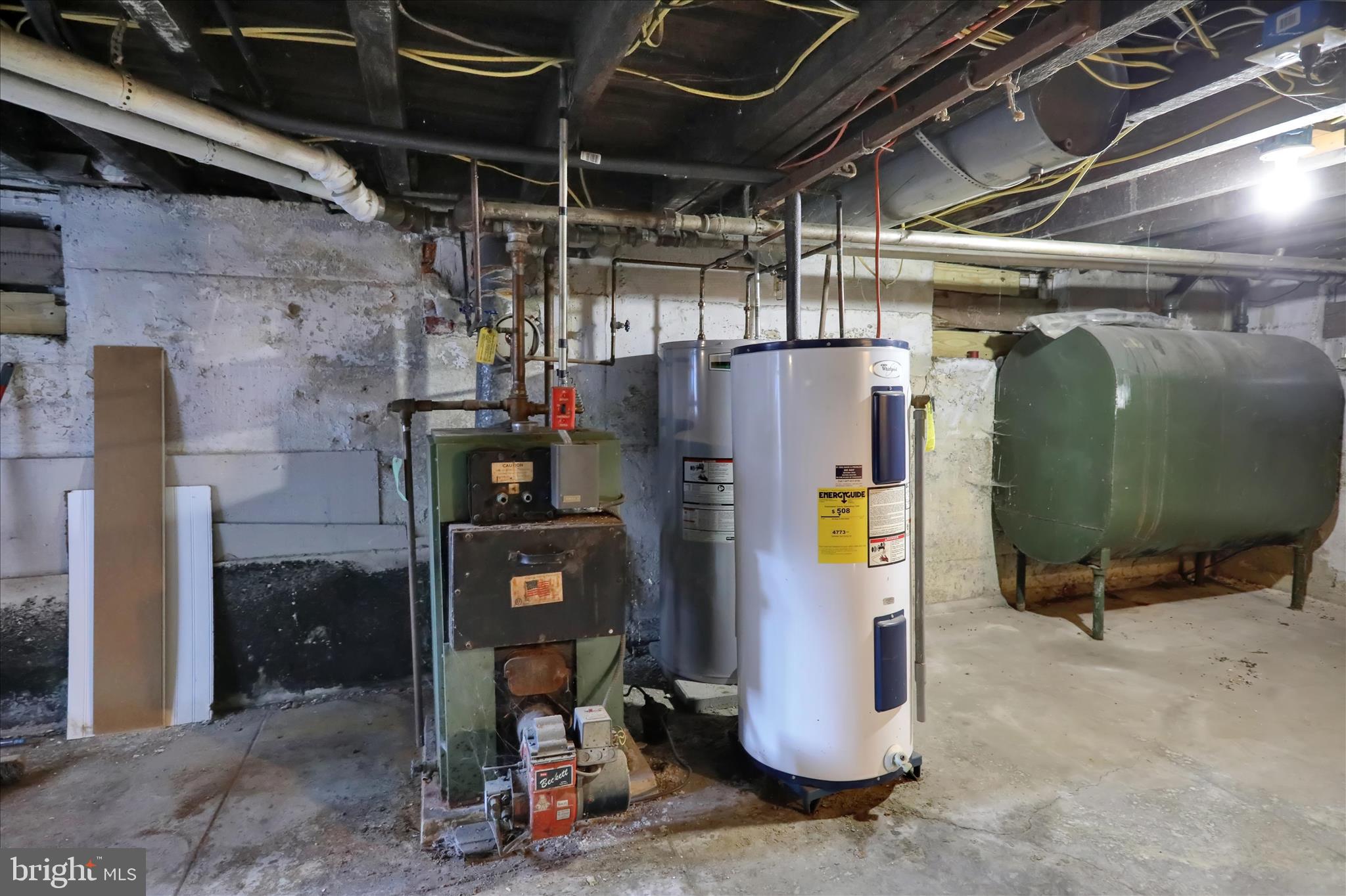 1410 Cotton Street Reading, PA 19602 - Photo 29 of 37 a view of a storage room with water heater and racks