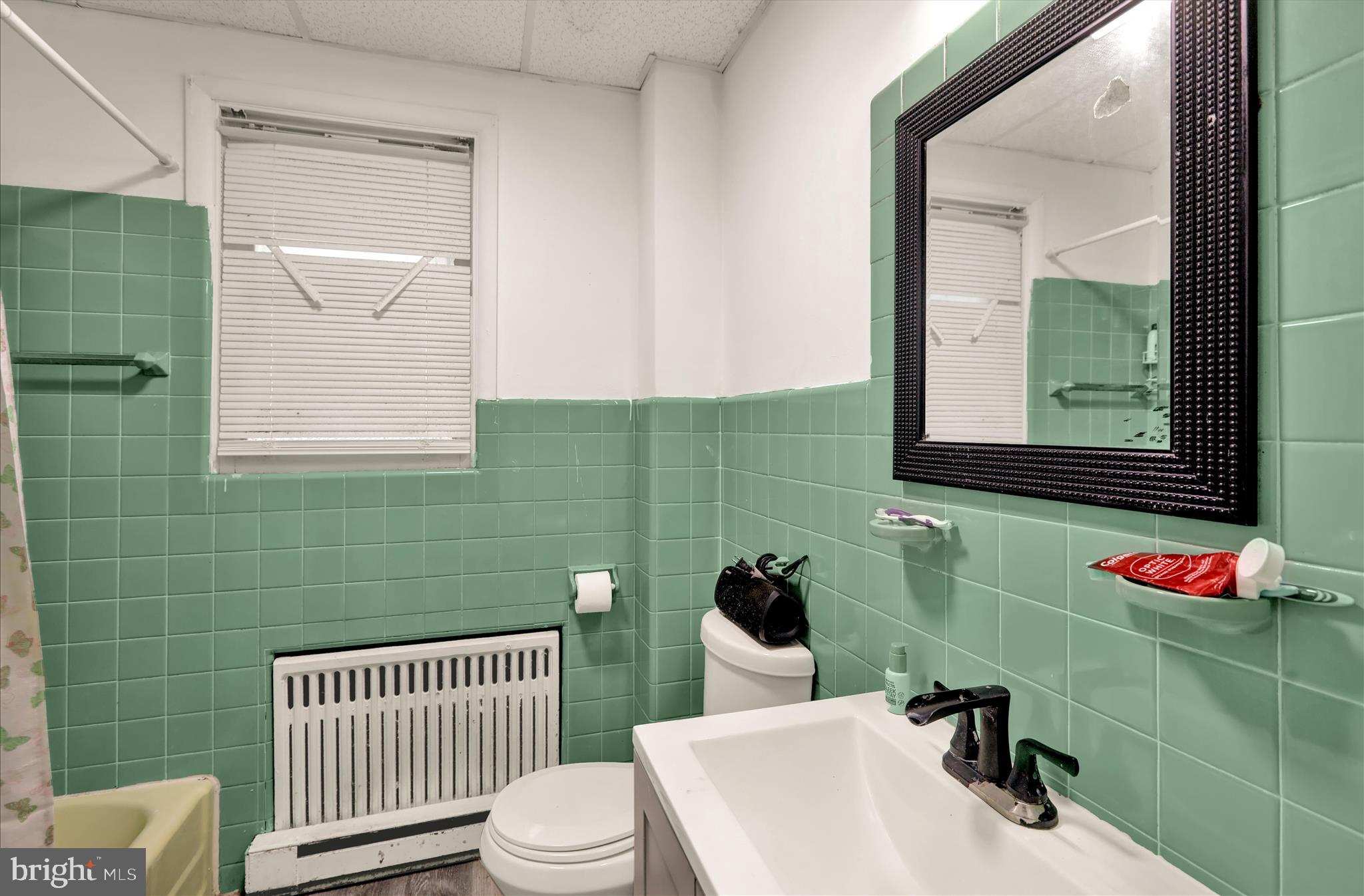 1410 Cotton Street Reading, PA 19602 - Photo 10 of 37 a bathroom with a sink toilet and mirror