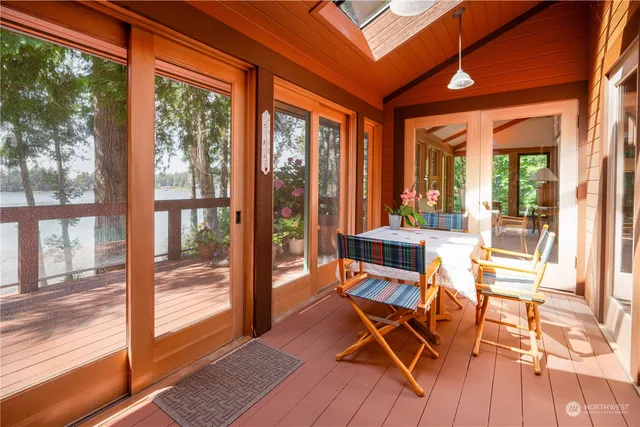 a dining room with furniture and floor to ceiling windows