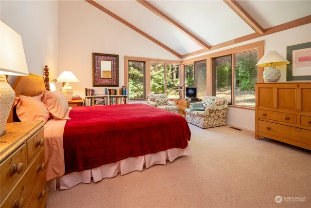 a spacious bedroom with a bed and large windows