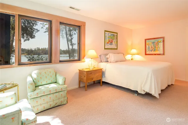 a bedroom with a bed couch and window