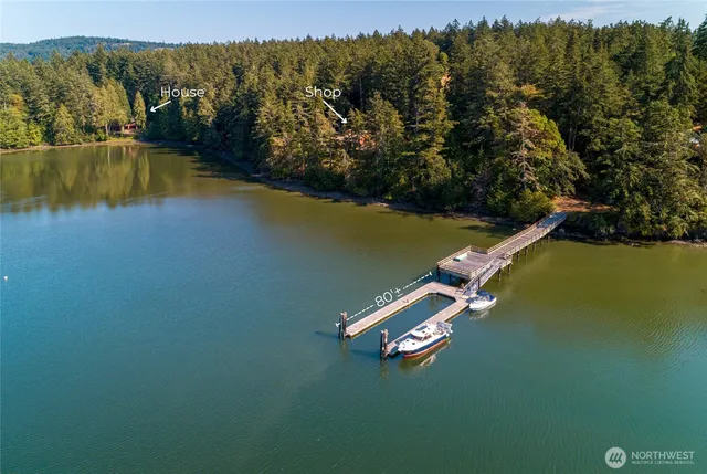 an aerial view of a residential house with outdoor space and lake view