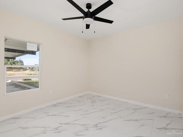 611 Mountain Road, Unit A Mission, TX 78573 - Photo 10 of 12 an empty room with a window and a ceiling fan