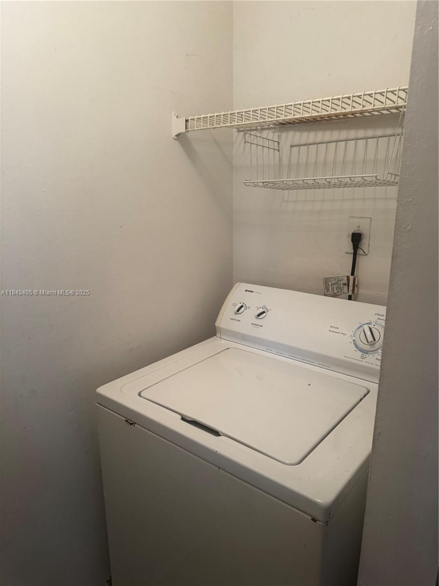 1227 Southwest 46th Avenue, Unit 314 Pompano Beach, FL 33069 - Photo 11 of 36 a utility room with dryer and washer