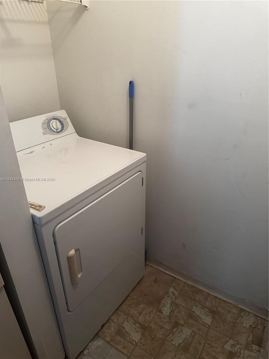 1227 Southwest 46th Avenue, Unit 314 Pompano Beach, FL 33069 - Photo 12 of 36 a utility room with dryer and washer
