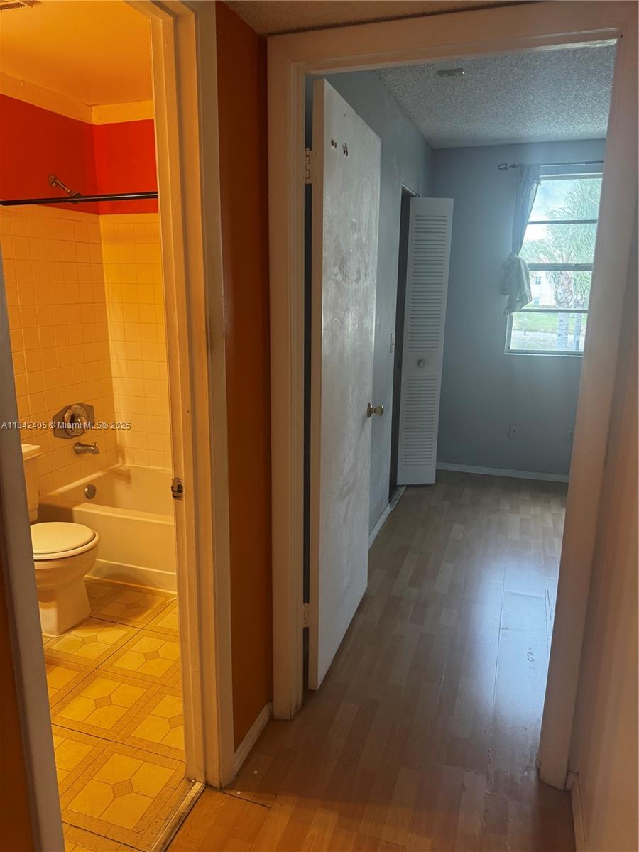 1227 Southwest 46th Avenue, Unit 314 Pompano Beach, FL 33069 - Photo 18 of 36 a view of a bathroom with a glass door