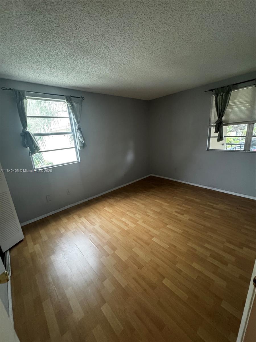 1227 Southwest 46th Avenue, Unit 314 Pompano Beach, FL 33069 - Photo 19 of 36 an empty room with a window